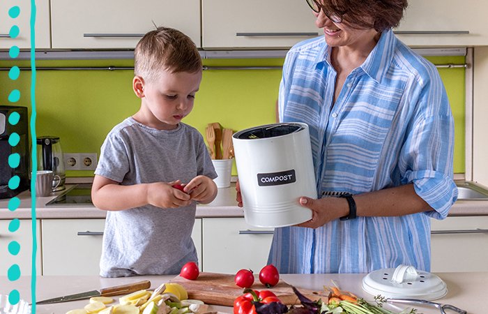 An adult and a child standing at a counter cooking together