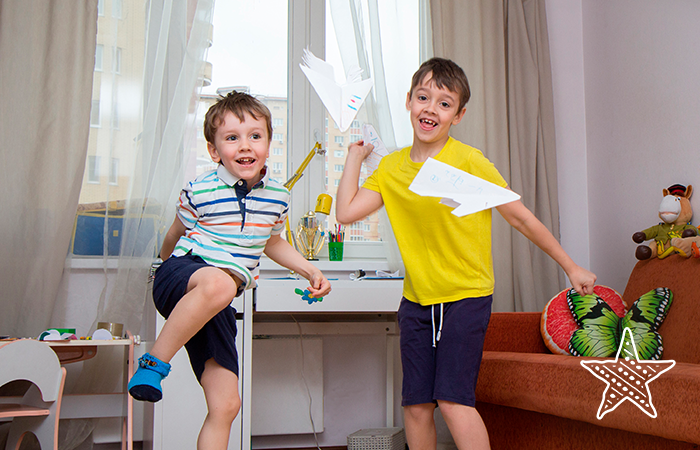 Kids playing with paper airplanes