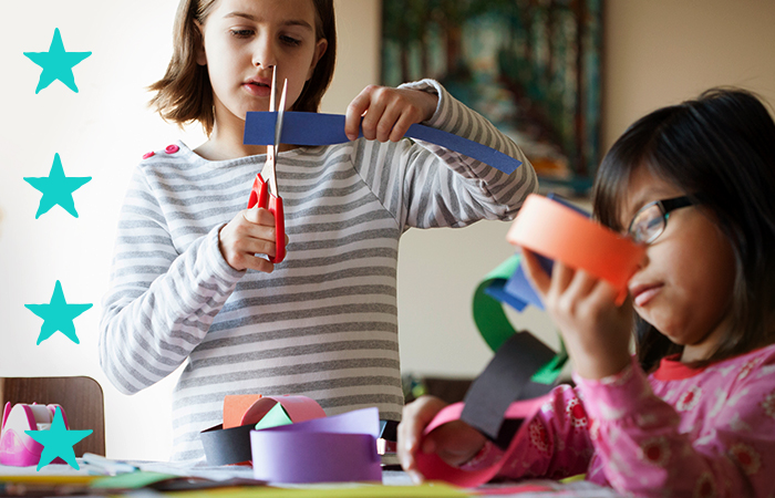 Young girls working with construction paper