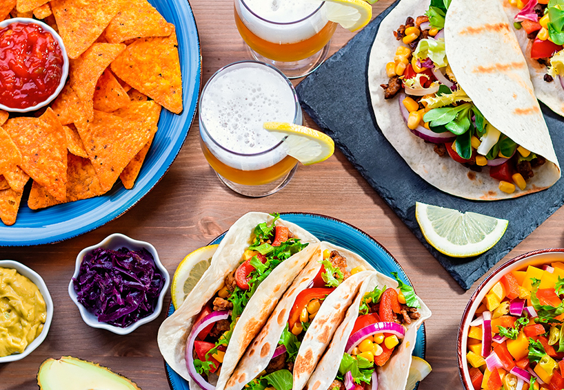 Tacos, chips, salsa, corn, black beans, avocado, beer