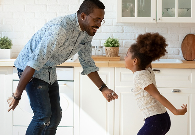 Dad and daughter dancing in the kitchen