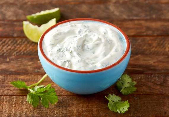 Small bowl of sour cream mixed with cilantro