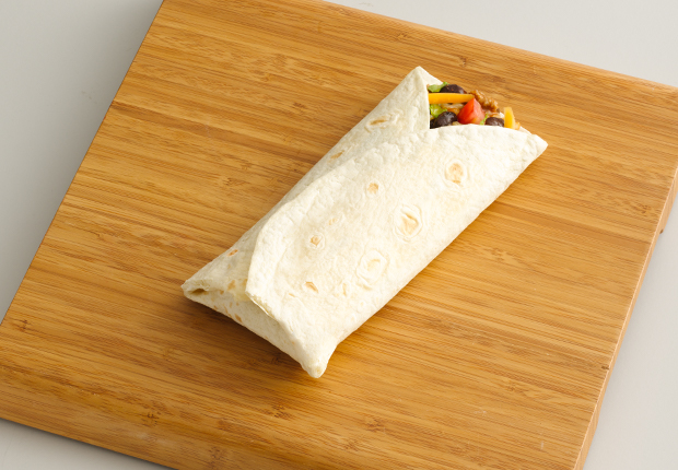 Fold the right third of the tortilla over the ingredients with the left third of the tortilla folded over and the bottom third of the tortilla folded up