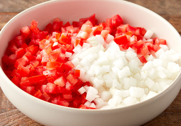 Diced tomato and diced white onion in a bowl